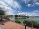 Beautiful lakefront with lush greenery and palm trees on a sunny day at 9028 Cypress Point Way, Las Vegas, NV 89117