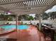 Backyard featuring a luxurious pool with a spa, surrounded by lounge seating and a covered pergola at 9028 Cypress Point Way, Las Vegas, NV 89117