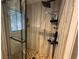 Modern shower featuring rainfall shower head, sleek fixtures, and neutral stone-look tile at 9028 Cypress Point Way, Las Vegas, NV 89117