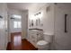 Renovated bathroom featuring a white vanity, updated lighting, a toilet, and a fully tiled shower at 950 Seven Hills Dr # 114, Henderson, NV 89052