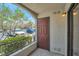 Private outdoor patio with a door leading to the unit and green landscaping at 950 Seven Hills Dr # 114, Henderson, NV 89052