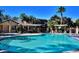 Inviting community pool with shade structure surrounded by lounge chairs and mature landscaping at 950 Seven Hills Dr # 114, Henderson, NV 89052