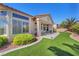 Inviting backyard showcasing lush turf, attractive landscaping, and a covered patio at 9916 Netherton Dr, Las Vegas, NV 89134