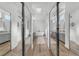 Hallway view of dual sink vanity and soaking tub in modern bathroom at 9916 Netherton Dr, Las Vegas, NV 89134