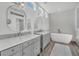 Bright bathroom features dual vanities and soaking tub at 9916 Netherton Dr, Las Vegas, NV 89134