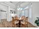 Cozy dining area with wood floors, a bay window, and a modern chandelier at 9916 Netherton Dr, Las Vegas, NV 89134