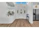 Bright foyer with wood flooring, decorative front door, and adjacent stainless steel refrigerator at 9916 Netherton Dr, Las Vegas, NV 89134