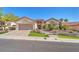Inviting single-story home with manicured landscaping, tile roof, and spacious two-car garage at 9916 Netherton Dr, Las Vegas, NV 89134