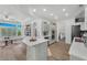 Spacious kitchen with a breakfast bar, stainless steel appliances, and seamless flow to the living area at 9916 Netherton Dr, Las Vegas, NV 89134