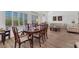 Comfortable living and dining area showcasing wood-style flooring and a classic dining set at 9916 Netherton Dr, Las Vegas, NV 89134
