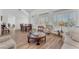 Open concept living and dining area with plantation shutters and wood-style flooring at 9916 Netherton Dr, Las Vegas, NV 89134