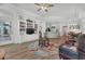 Bright living room with built-in bookshelves, wood floors, and access to the kitchen and outdoor area at 9916 Netherton Dr, Las Vegas, NV 89134