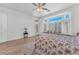 Spacious bedroom featuring a floral bedspread, ceiling fan and bay window at 9916 Netherton Dr, Las Vegas, NV 89134