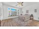 Bright main bedroom with a bay window, built-in seating, and wood floors at 9916 Netherton Dr, Las Vegas, NV 89134