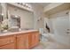 A bathroom featuring a granite vanity with a bathtub and shower at 10001 Peace Way # 2231, Las Vegas, NV 89147