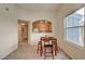 A cozy dining area with a dark wood table set and window view adjacent to the kitchen at 10001 Peace Way # 2231, Las Vegas, NV 89147