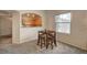 A cozy dining area features a wooden table set with stools and gray carpeting at 10001 Peace Way # 2231, Las Vegas, NV 89147