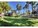 Beautifully landscaped community building surrounded by lush greenery and tall palm trees at 10001 Peace Way # 2231, Las Vegas, NV 89147