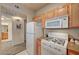 A well-organized kitchen with white appliances and light wood cabinets at 10001 Peace Way # 2231, Las Vegas, NV 89147