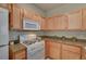 A kitchen with white appliances, light wood cabinets and granite countertops at 10001 Peace Way # 2231, Las Vegas, NV 89147