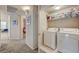 Convenient laundry area with modern appliances and organized shelving for supplies at 10001 Peace Way # 2231, Las Vegas, NV 89147