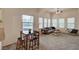 Bright living room with a modern sofa, glass coffee table, and high ceilings, adjacent to dining area at 10001 Peace Way # 2231, Las Vegas, NV 89147