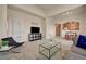 Open-concept living room boasts a glass coffee table, natural light, and comfortable seating at 10001 Peace Way # 2231, Las Vegas, NV 89147