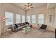 Bright living room boasts multiple windows, plush seating, ceiling fan and contemporary decor at 10001 Peace Way # 2231, Las Vegas, NV 89147