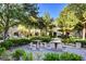 Charming outdoor area with stone seating, tables, and BBQ grills at 10001 Peace Way # 2231, Las Vegas, NV 89147