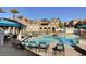 Community pool with lounge chairs for relaxing in a resort-style setting at 10001 Peace Way # 2231, Las Vegas, NV 89147