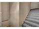 Neutral carpeted stairs with white walls and trim, complemented by landing with base trim at 10001 Peace Way # 2231, Las Vegas, NV 89147