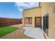 A cozy backyard features a covered patio, artificial turf, and a brick wall, ideal for relaxation and outdoor enjoyment at 10617 Hartford Hills Ave, Las Vegas, NV 89166