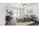 Cozy bedroom with neutral tones, a ceiling fan, and a sliding glass door to the outside at 10617 Hartford Hills Ave, Las Vegas, NV 89166