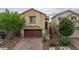 Charming two-story home featuring a neat brick driveway and a well-maintained landscaped front yard at 10617 Hartford Hills Ave, Las Vegas, NV 89166