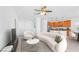 Bright living room with neutral tones, a ceiling fan, and views into the kitchen at 10617 Hartford Hills Ave, Las Vegas, NV 89166