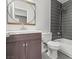 Modern bathroom features a new vanity, stylish round mirror, and a shower over the tub with a gray tile accent wall at 1112 Observation Dr # 201, Las Vegas, NV 89128