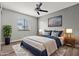 Bright bedroom boasts a ceiling fan, a large window for natural light, and is staged with stylish furniture and decor at 1112 Observation Dr # 201, Las Vegas, NV 89128