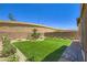 Well-manicured backyard with manicured lawn and attractive landscaping, creating a private outdoor retreat at 12546 Mosticone Way, Las Vegas, NV 89141