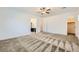 Spacious bedroom with neutral carpet, ceiling fan, and doorways to bathroom and closet at 12546 Mosticone Way, Las Vegas, NV 89141