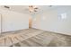 Bright bedroom with neutral carpet, ceiling fan, and windows letting in natural light at 12546 Mosticone Way, Las Vegas, NV 89141