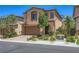 Charming two-story home featuring a two-car garage, stone accents, and professionally landscaped front yard at 12546 Mosticone Way, Las Vegas, NV 89141