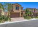 Charming two-story home featuring a two-car garage, stone accents, and professionally landscaped front yard at 12546 Mosticone Way, Las Vegas, NV 89141