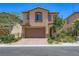 Charming two-story home featuring a two-car garage, stone accents, and professionally landscaped front yard at 12546 Mosticone Way, Las Vegas, NV 89141