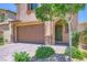 Home featuring a two-car garage, stone accents, and a covered front entry at 12546 Mosticone Way, Las Vegas, NV 89141