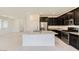 Modern kitchen featuring a central island with granite countertops and stainless steel appliances at 12546 Mosticone Way, Las Vegas, NV 89141