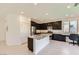 Modern kitchen with dark cabinetry, stainless steel appliances, granite countertops, and a kitchen island at 12546 Mosticone Way, Las Vegas, NV 89141
