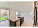 Bright kitchen features granite counters, stainless steel appliances, and backyard views through sliding glass doors at 12546 Mosticone Way, Las Vegas, NV 89141