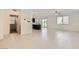 Open-concept living room and kitchen featuring tile floors and modern finishes at 12546 Mosticone Way, Las Vegas, NV 89141