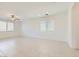 Bright and airy living room featuring large windows and neutral paint at 12546 Mosticone Way, Las Vegas, NV 89141