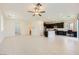 Bright and spacious living room and kitchen featuring tile floors and neutral paint at 12546 Mosticone Way, Las Vegas, NV 89141